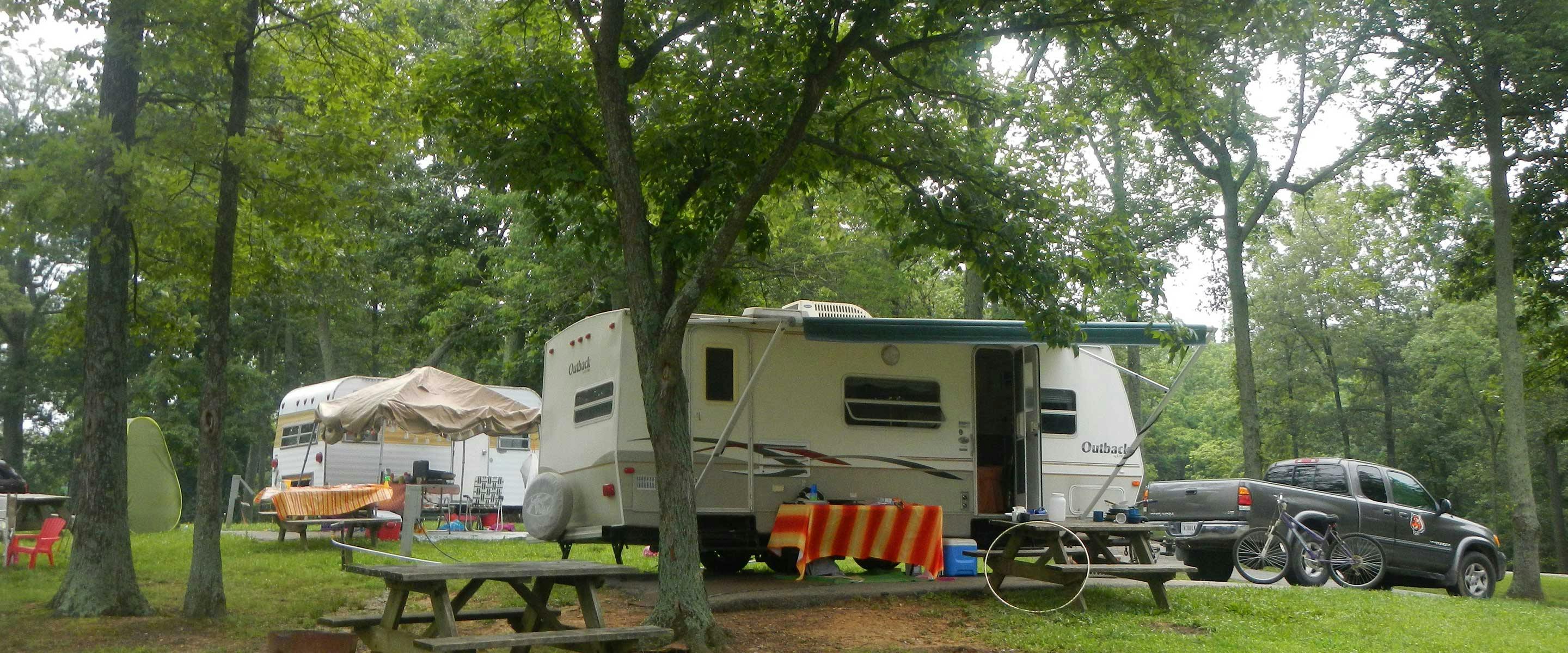 rv camper with tree backdrop on modern campsite at buffalo trace