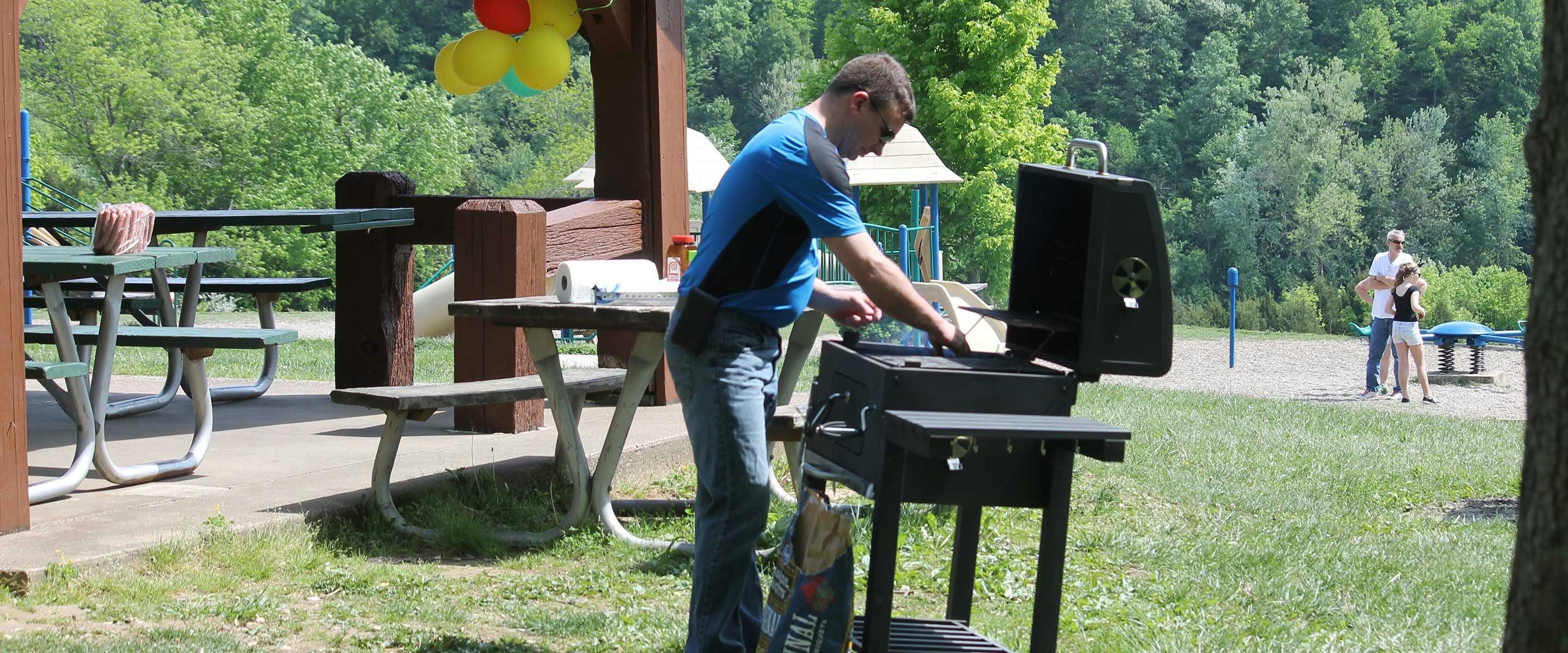 man preparing grill for meal