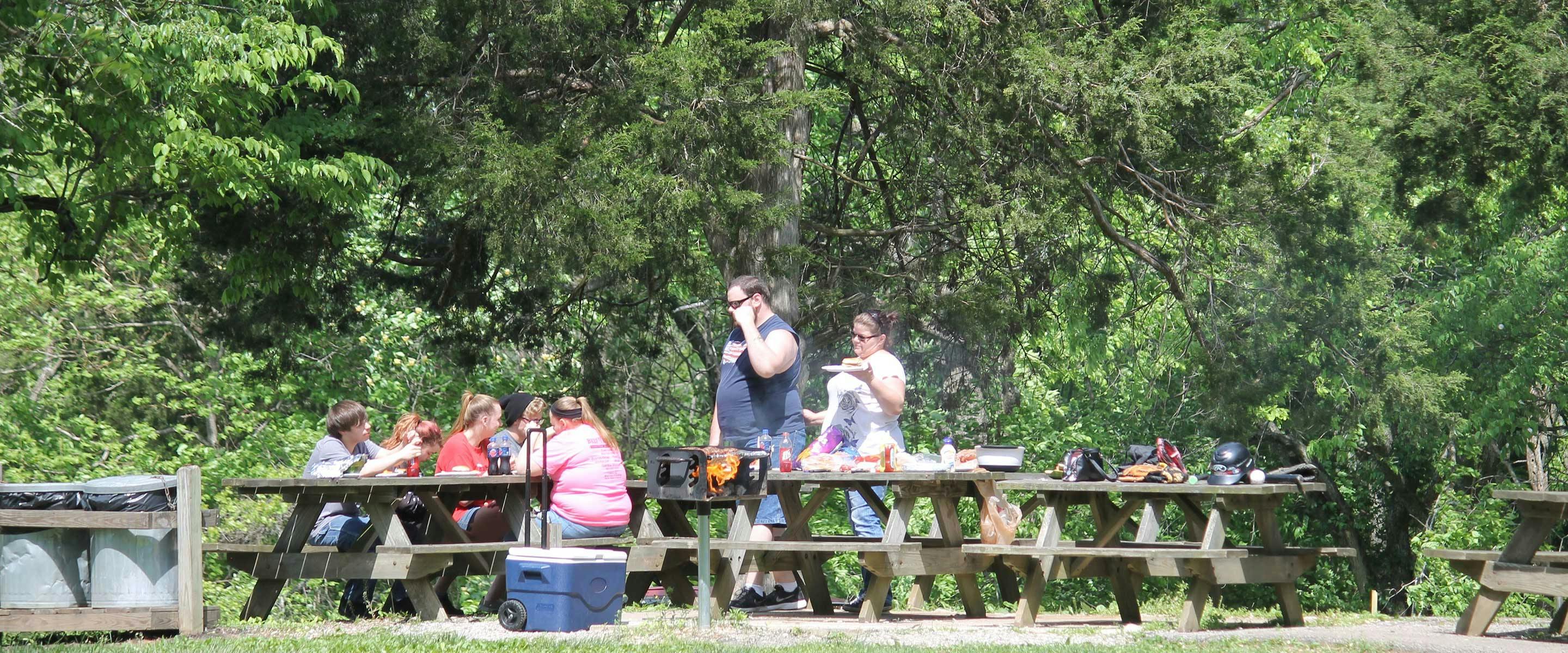 Couple enjoying a grilled meal at one of the picnic tables